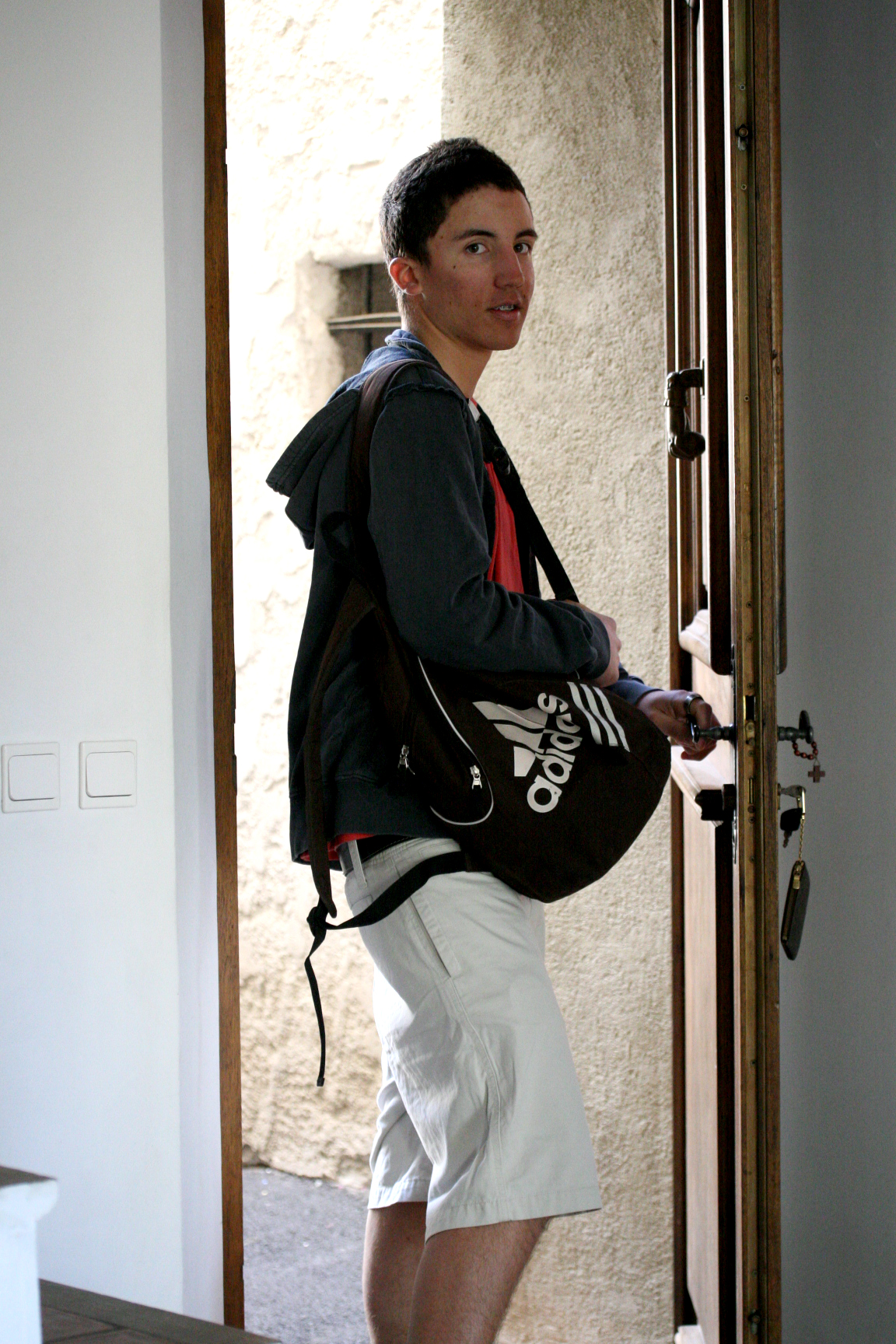 boy wearing dad's shorts