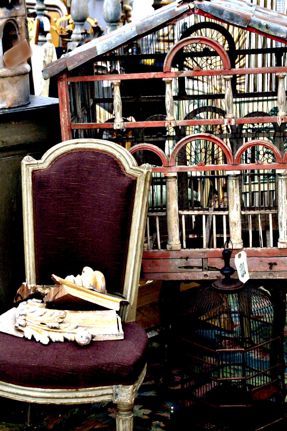French antique bird house and aubergine chair