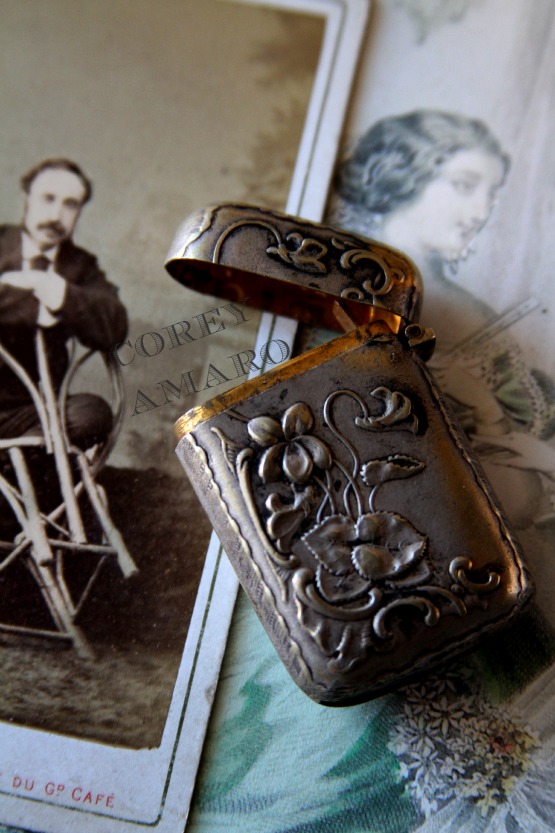 Silver match box, and man leaning on a chair Silver match box, and man leaning on a chair