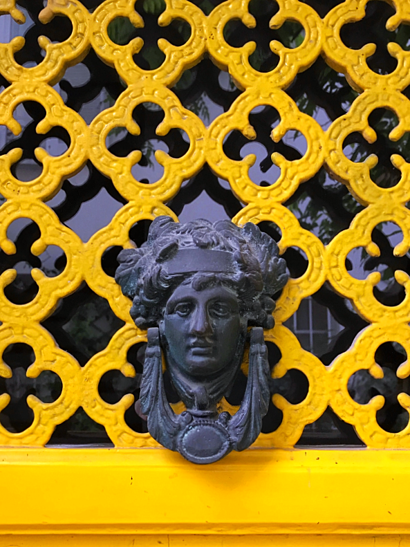 yellow door and knocker in Paris
